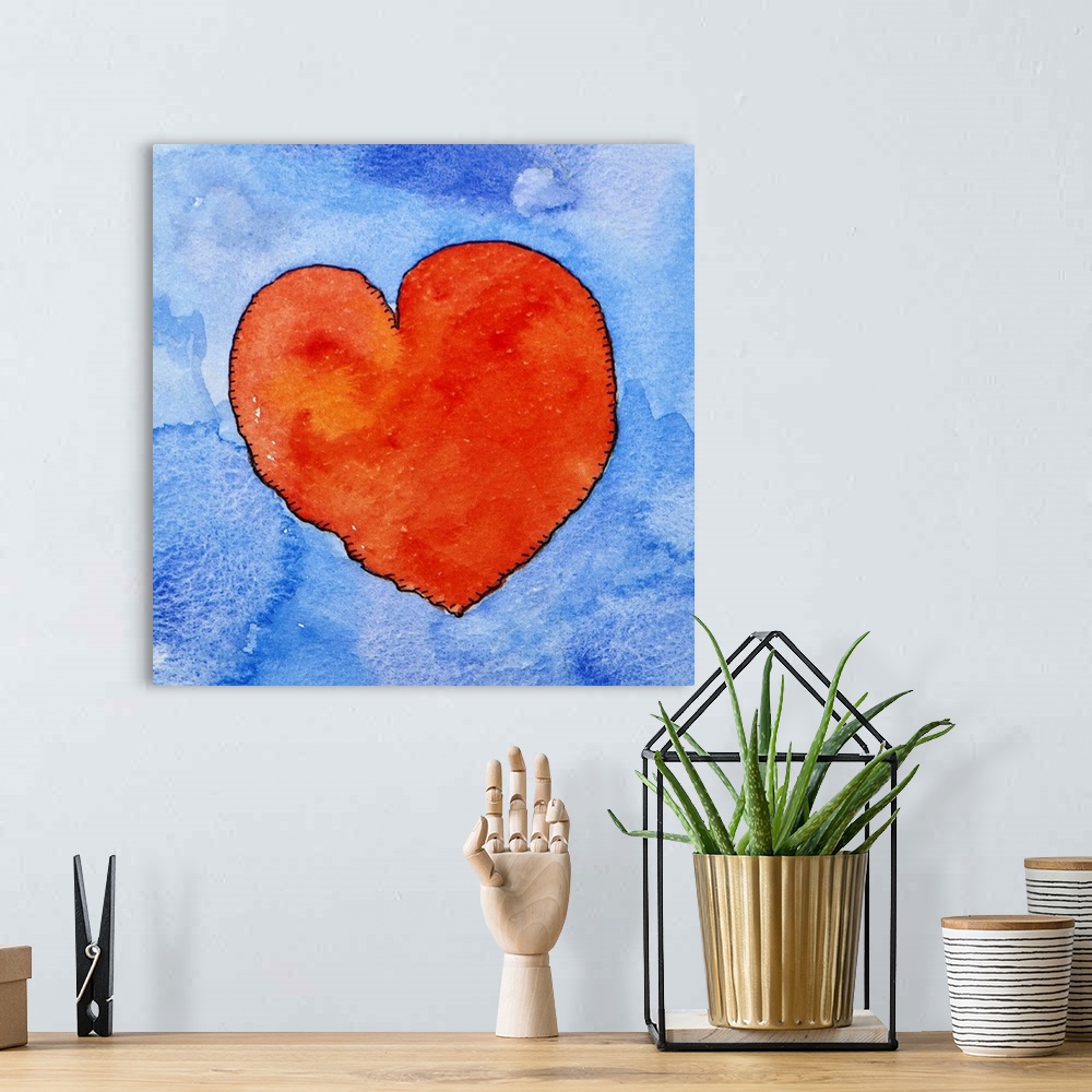 A bohemian room featuring Watercolor painting of a bright red heart against a light blue background.