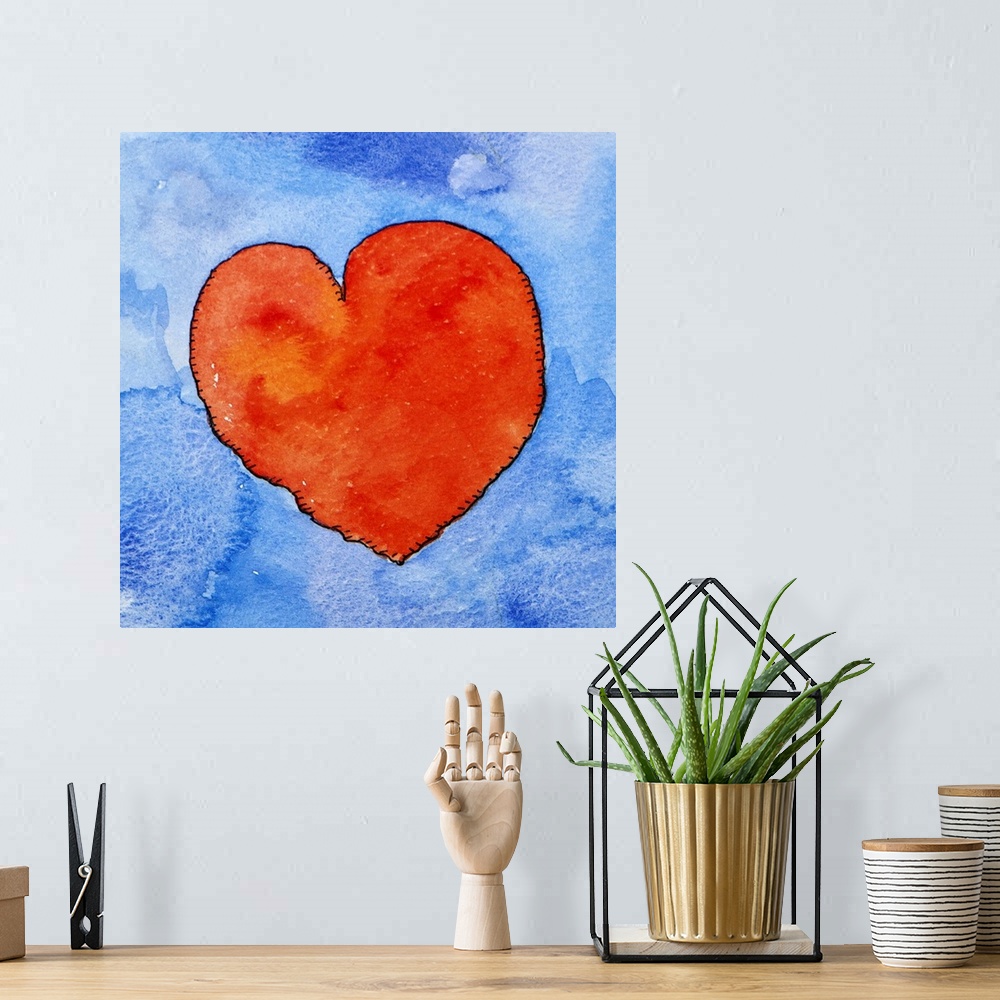 A bohemian room featuring Watercolor painting of a bright red heart against a light blue background.