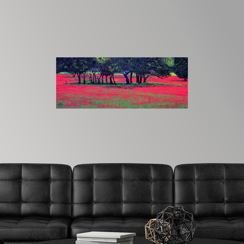 A modern room featuring Panoramic photo of a field or red flowers with clusters of tree in the middle of the field.
