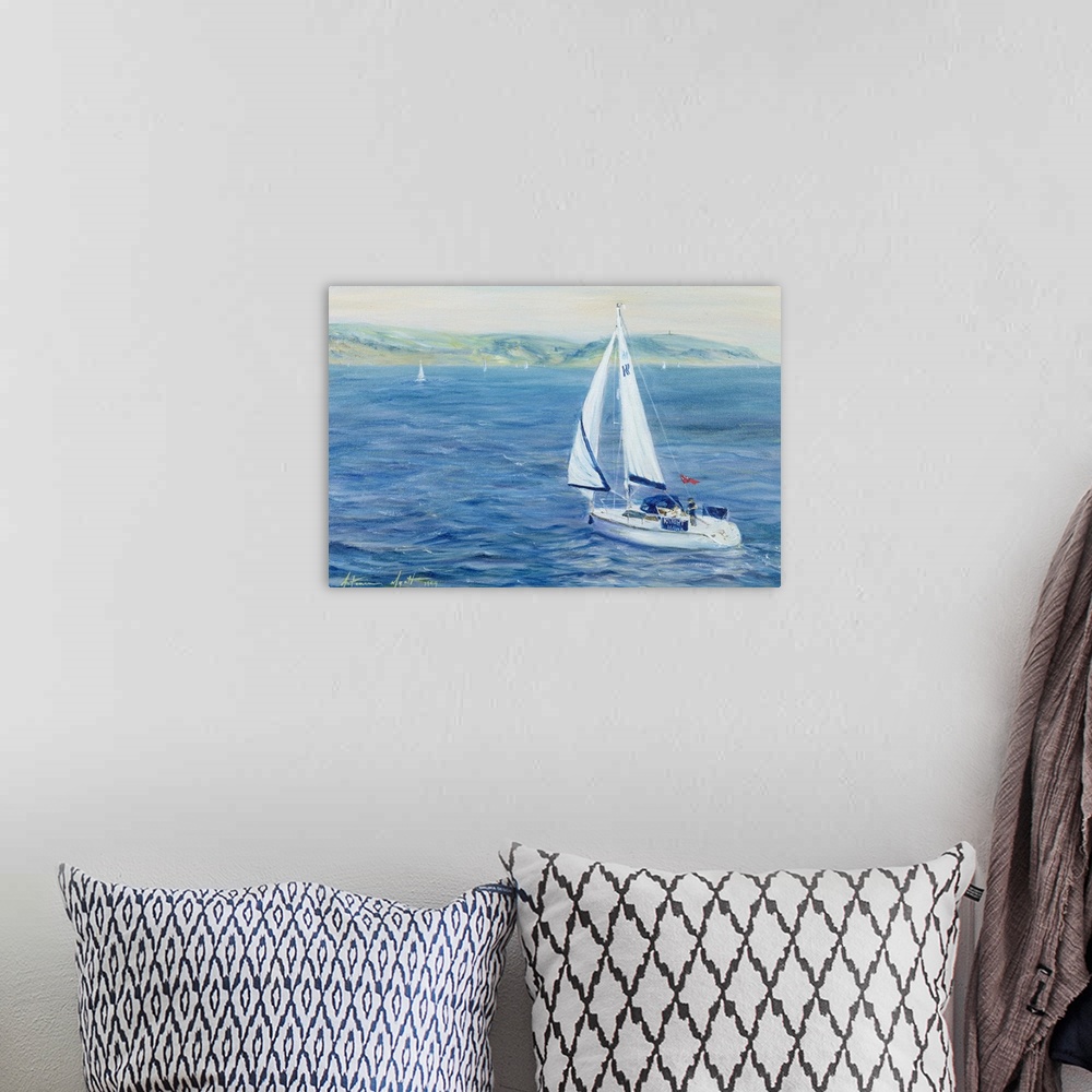 A bohemian room featuring This landscape painting of a sailboat off the coast is decorative wall art for the home or office.