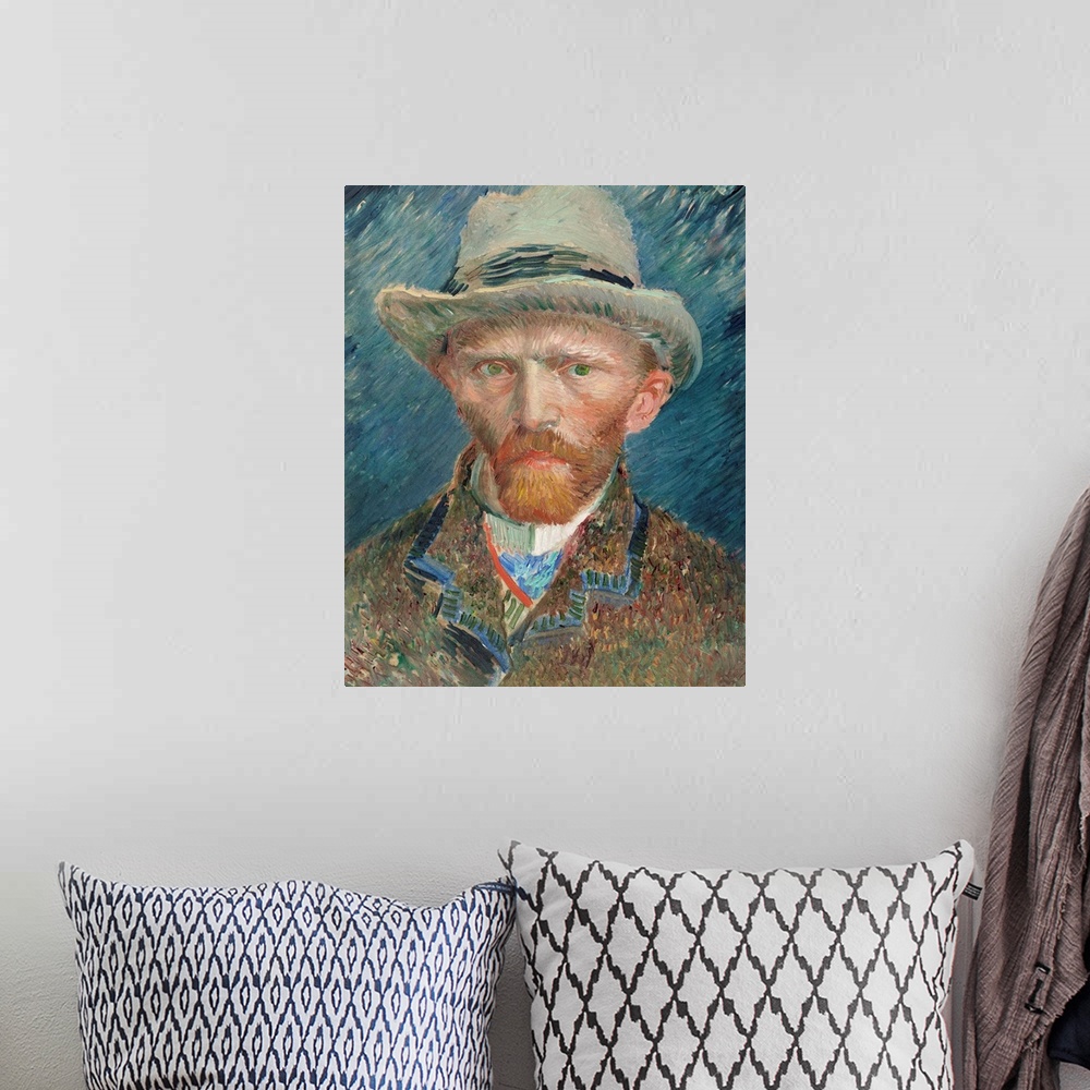 A bohemian room featuring Self portrait of Vincent Van Gogh wearing a hat.