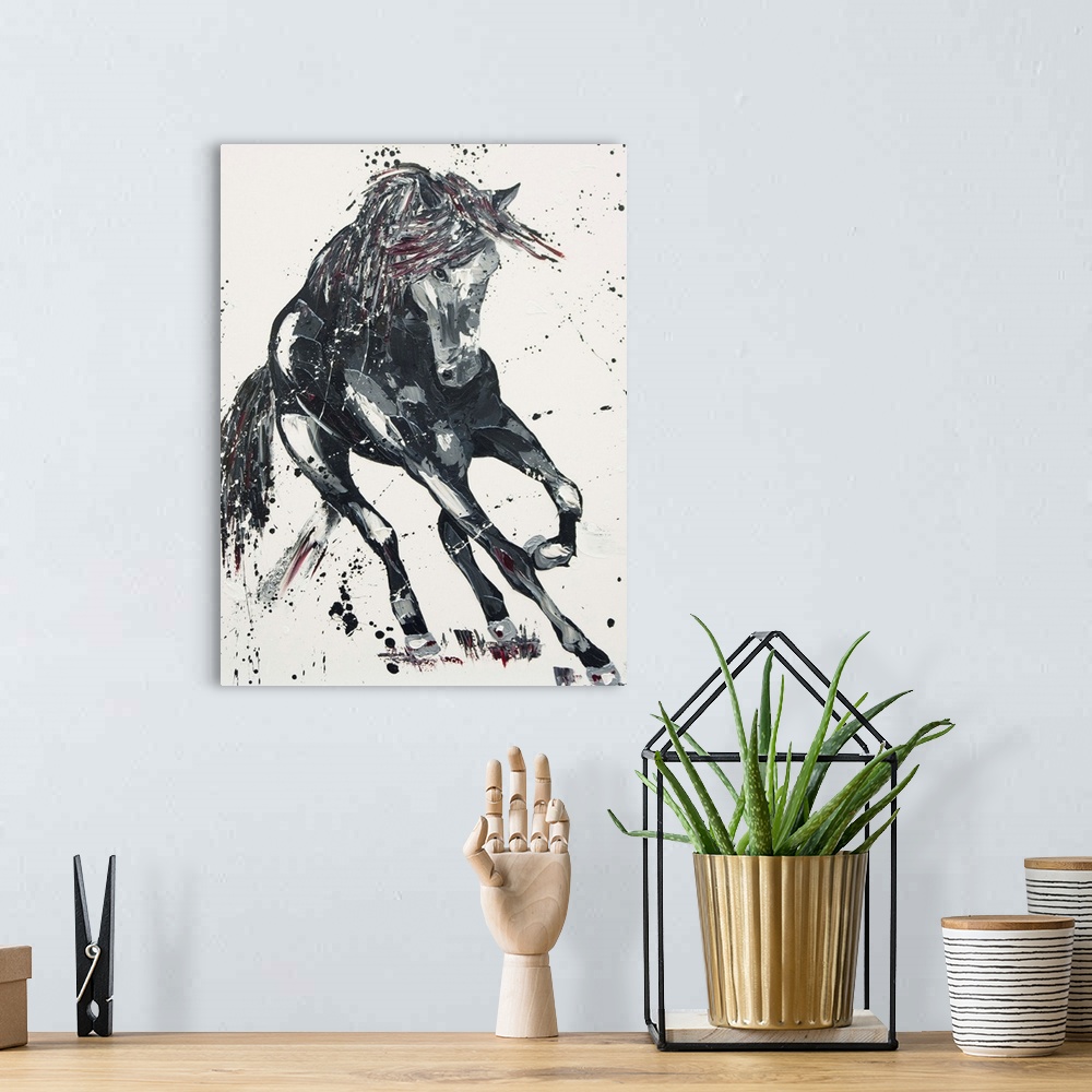 A bohemian room featuring Contemporary painting of a galloping horse in shades of black with red.