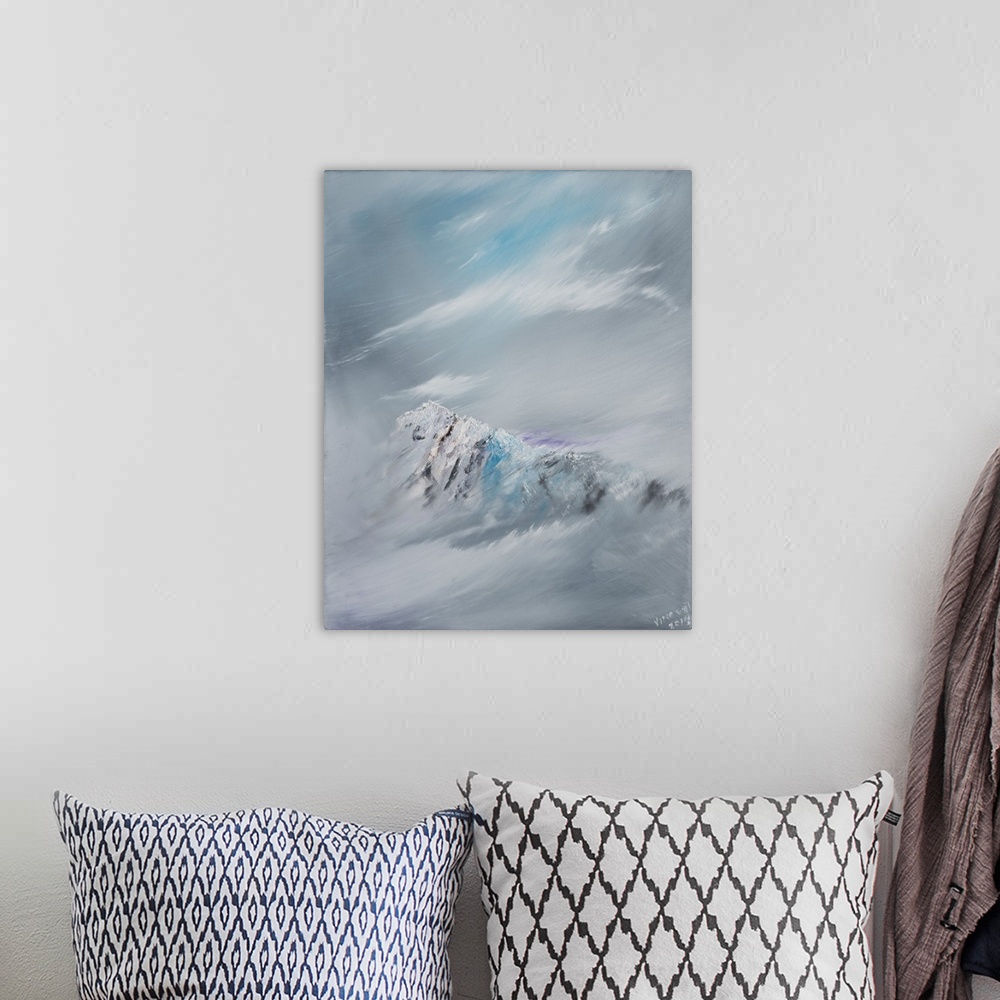 A bohemian room featuring Contemporary painting of a mountain peak shrouded in snow and clouds.