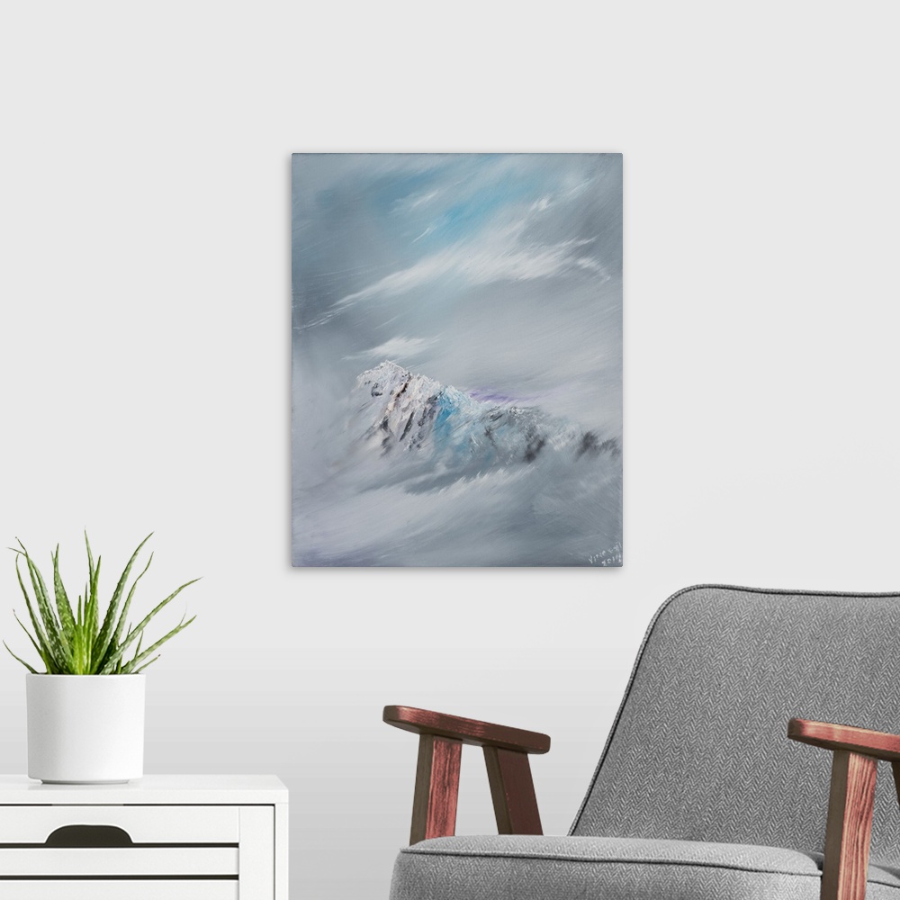 A modern room featuring Contemporary painting of a mountain peak shrouded in snow and clouds.