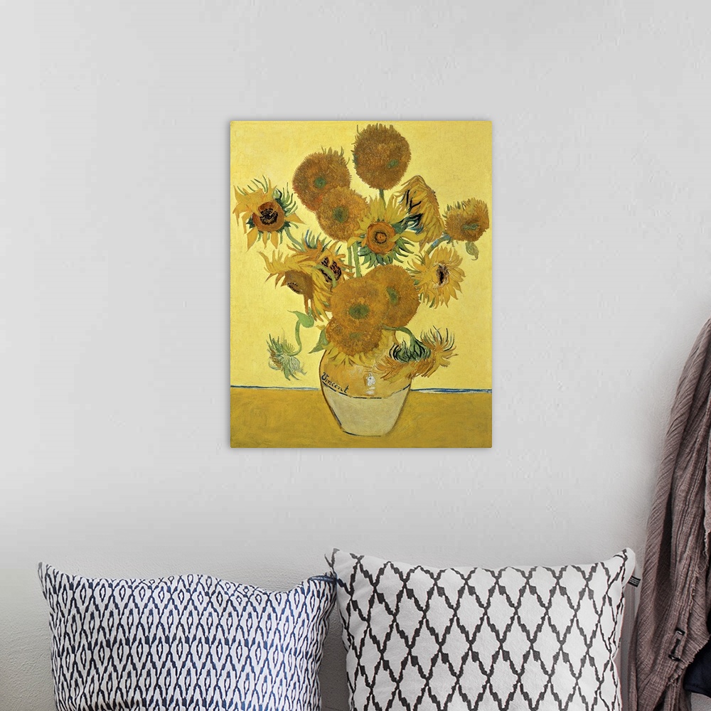 A bohemian room featuring Vincent Van Gogh's famous oil on canvas painting of sunflowers in a vase in warm tones.