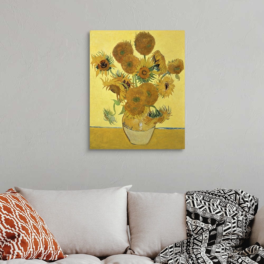 A bohemian room featuring Vincent Van Gogh's famous oil on canvas painting of sunflowers in a vase in warm tones.