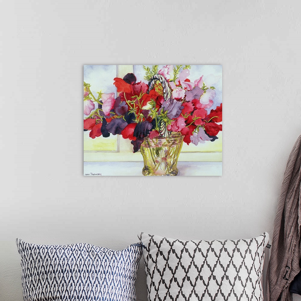 A bohemian room featuring Painting of colorful flowers in a brass container sitting on a table.