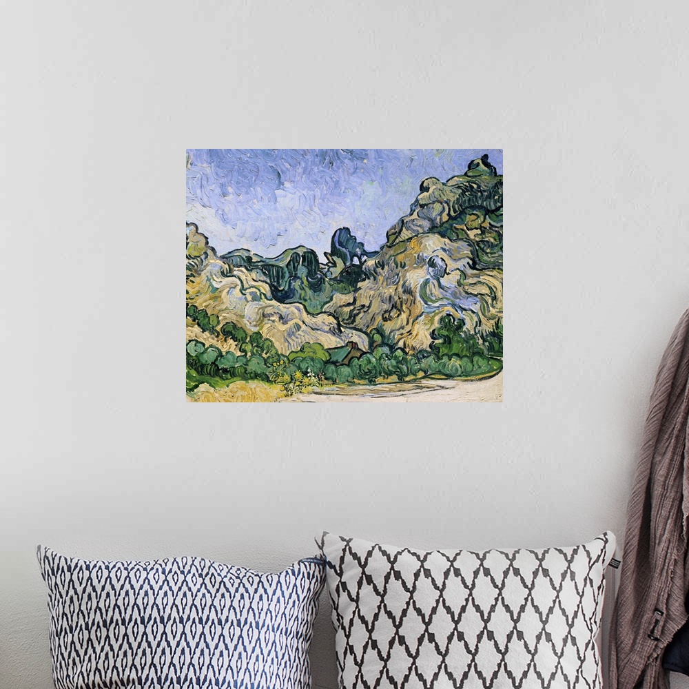 A bohemian room featuring A classic piece of artwork that has painted hills and trees just at the bottom. The roof of a sma...