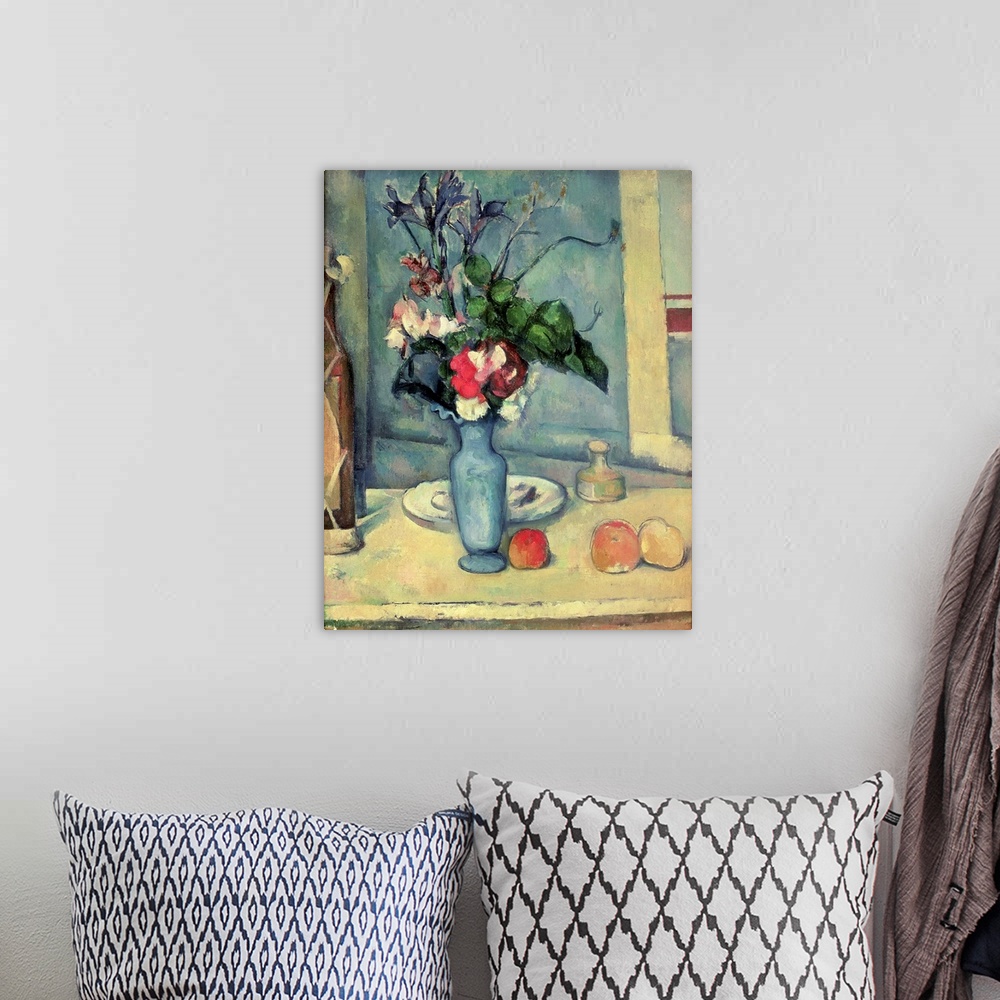 A bohemian room featuring Big canvas painting of a vase of flowers on a table with fruit, a bottle and a plate.