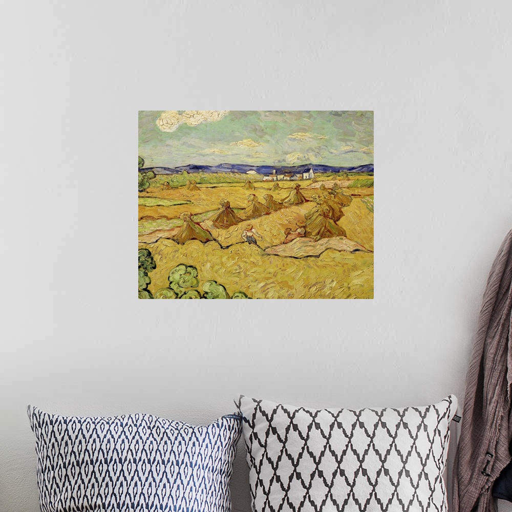 A bohemian room featuring Big wall art of a workers making stacks of hay in a field.