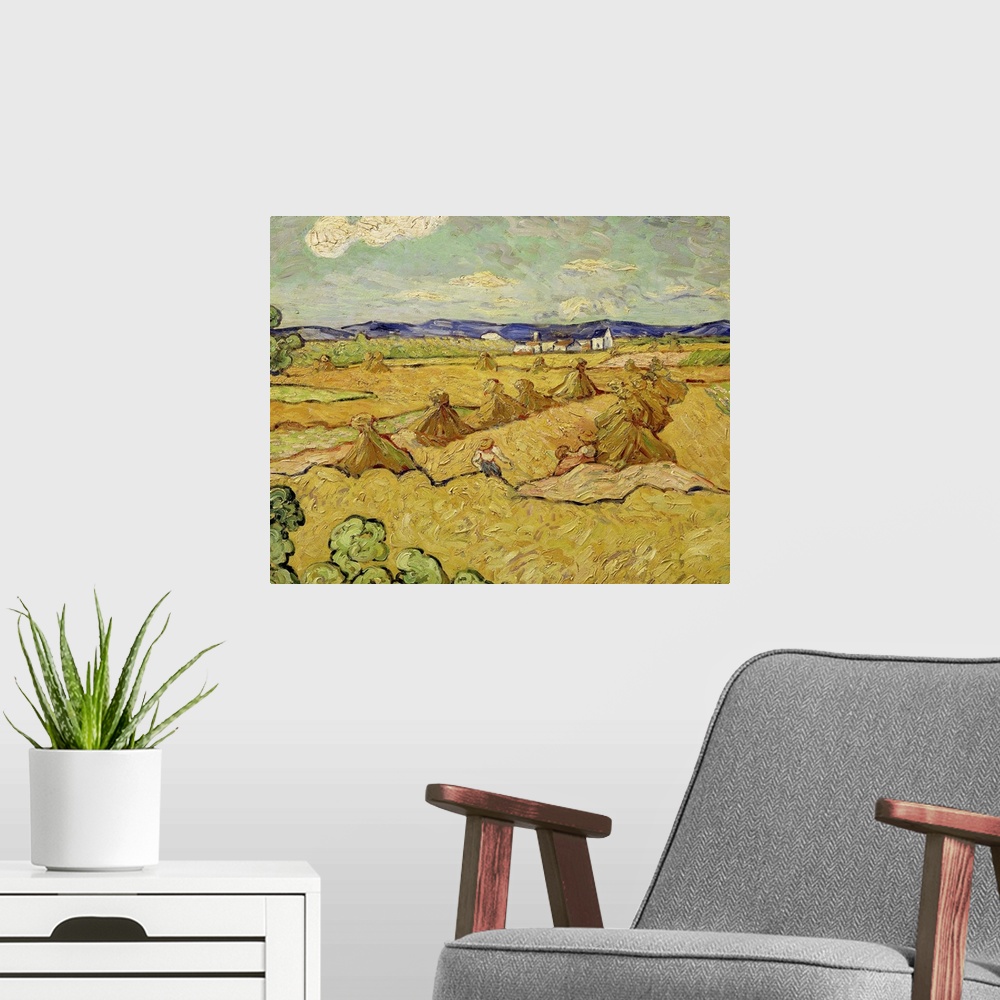 A modern room featuring Big wall art of a workers making stacks of hay in a field.