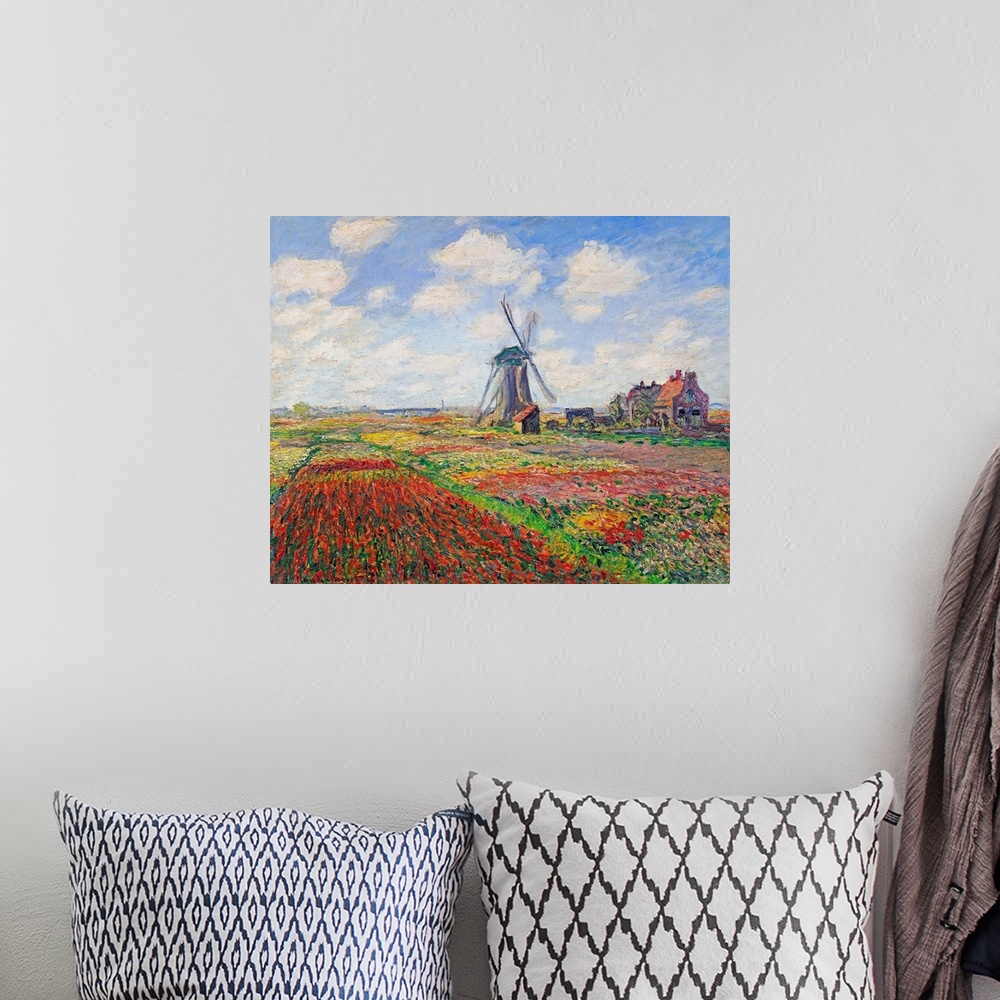 A bohemian room featuring Oil painting of a windmill in a field of bright flowers under a sky with puffy clouds.