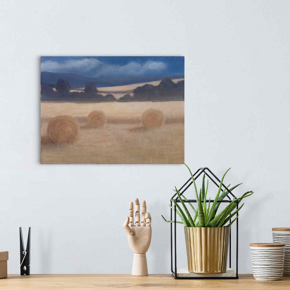 A bohemian room featuring Contemporary painting of a field in the summer with two rolled up bales of hay.