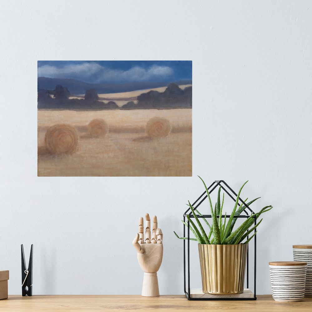 A bohemian room featuring Contemporary painting of a field in the summer with two rolled up bales of hay.