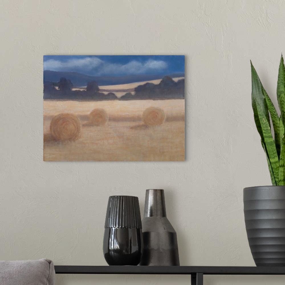A modern room featuring Contemporary painting of a field in the summer with two rolled up bales of hay.