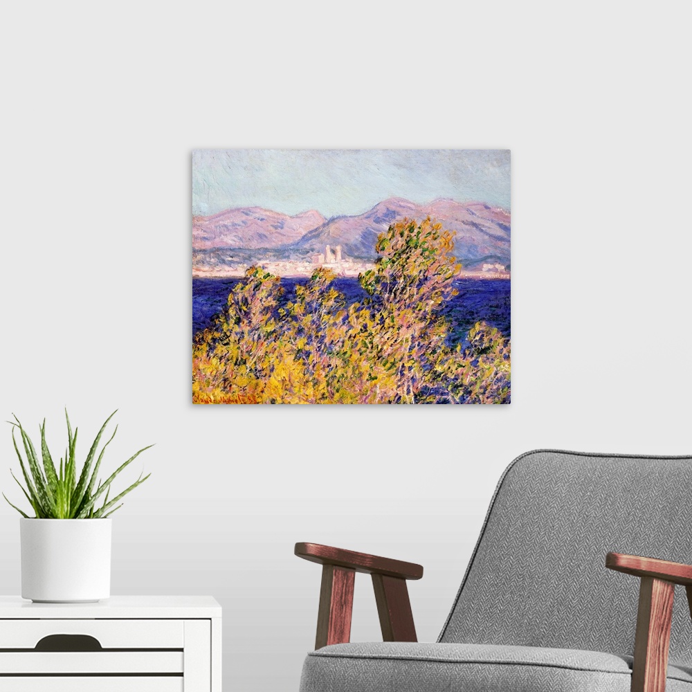 A modern room featuring Classical oil painting of tree tops blowing in the wind with an ocean and mountains in the distan...