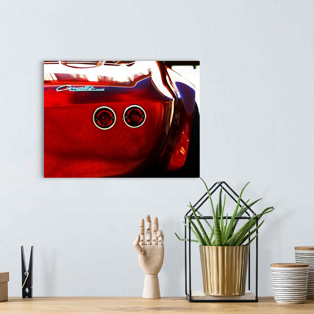 A bohemian room featuring Photograph of the rear and break lights of a red 1963 Corvette Stingray 15.