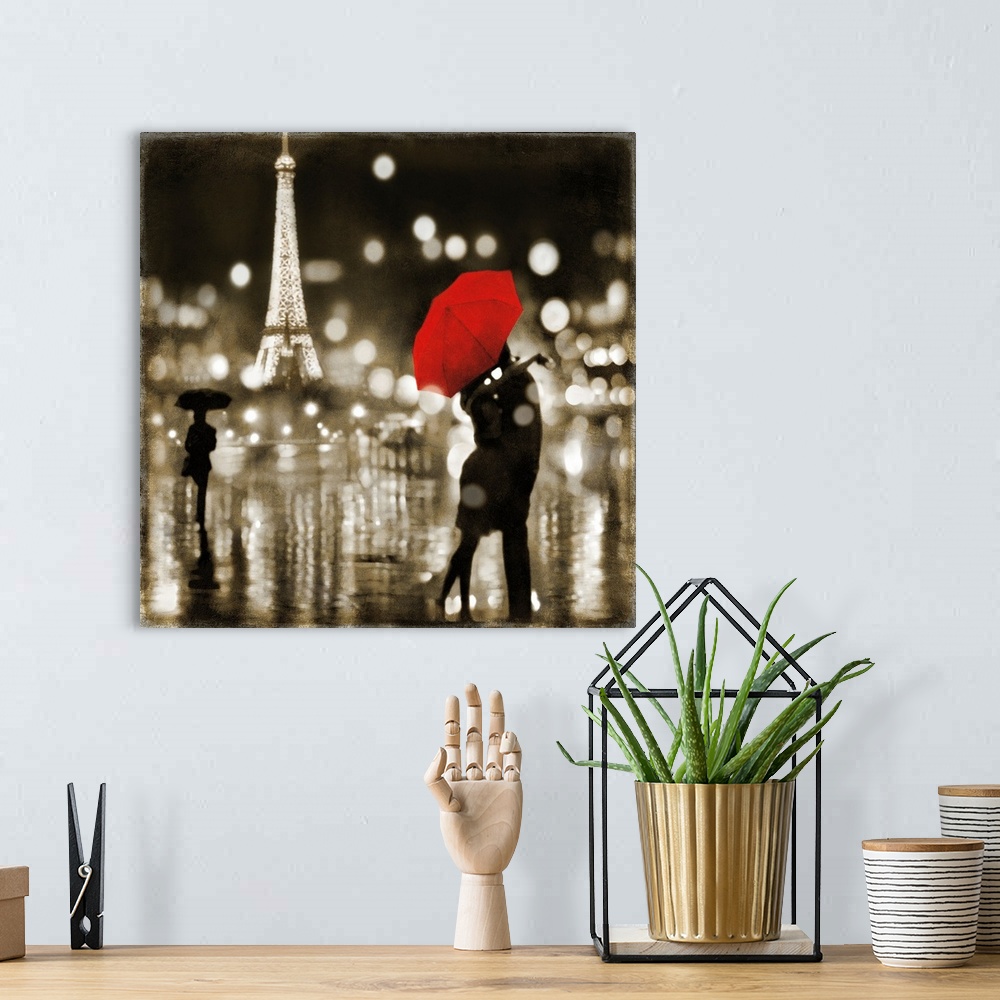 A bohemian room featuring Square art with a couple kissing under a red umbrella and the Eiffel Tower lit up in the background.