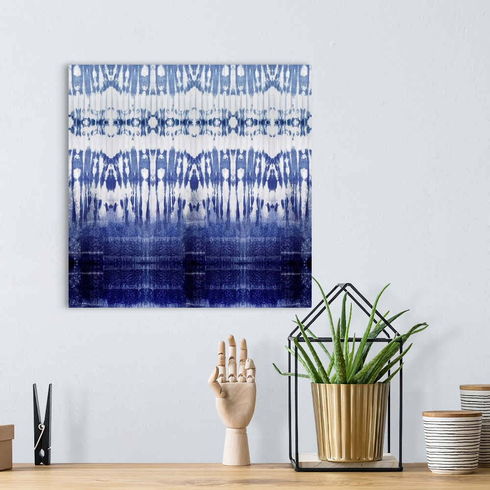 A bohemian room featuring Square abstract art with a blue and white pattern.
