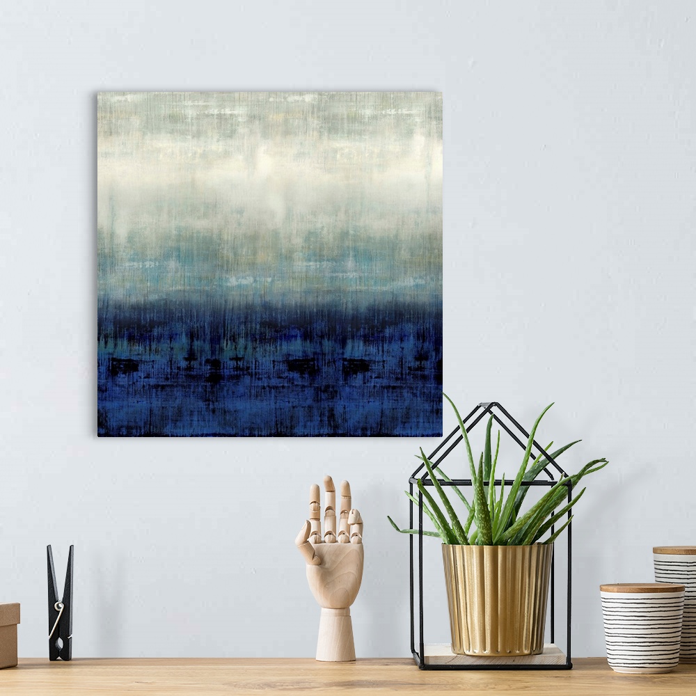 A bohemian room featuring Square abstract painting in shades of blue, gray, and white.