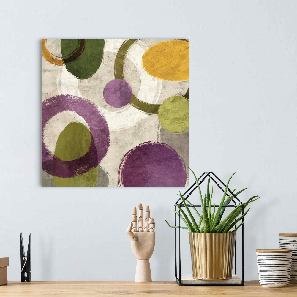A bohemian room featuring Square abstract art created with green, gold, purple, white, and gray different styled circles on...