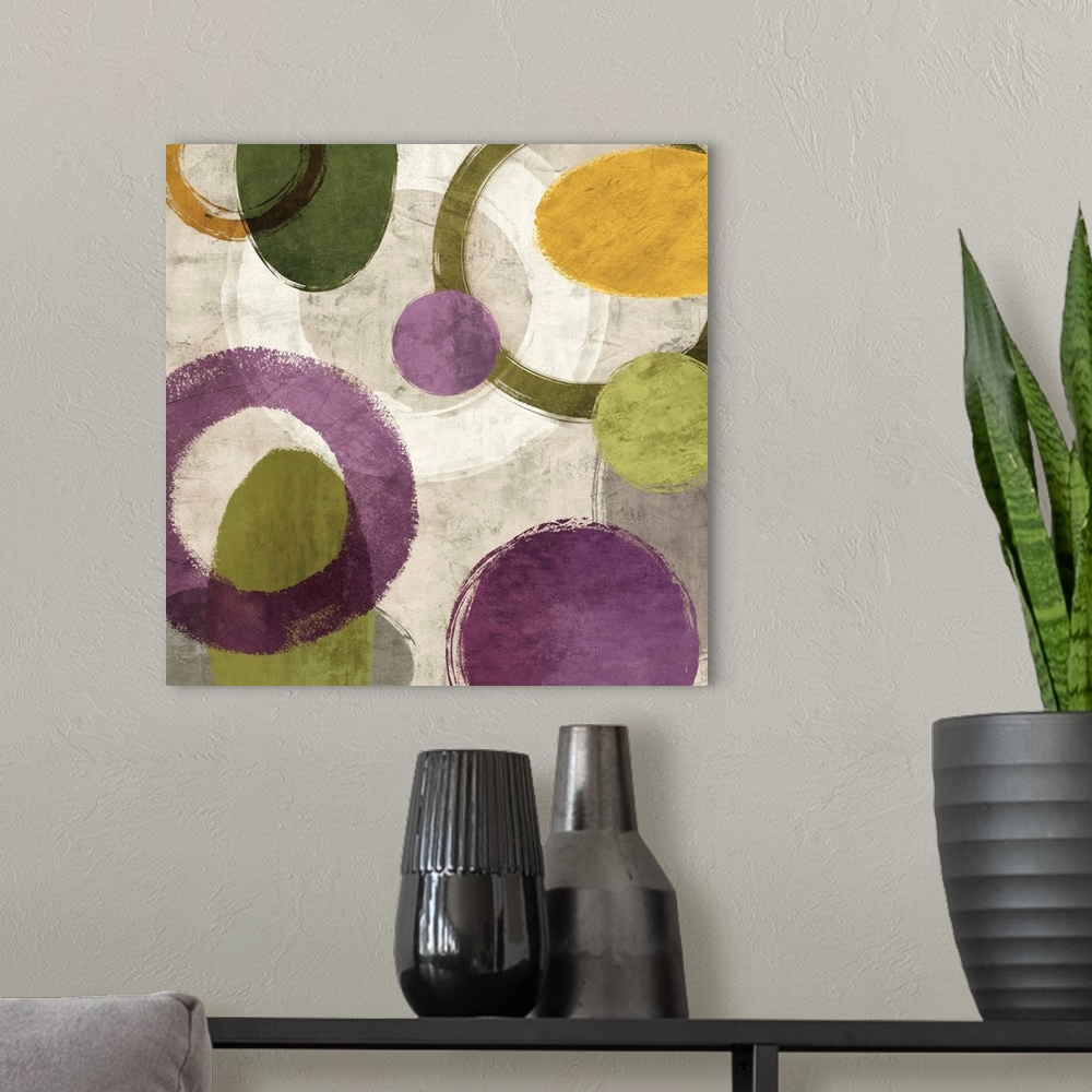 A modern room featuring Square abstract art created with green, gold, purple, white, and gray different styled circles on...