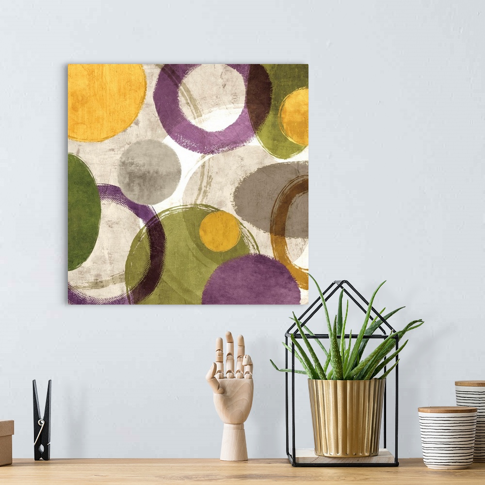 A bohemian room featuring Square abstract art created with green, gold, purple, white, and gray different styled circles on...