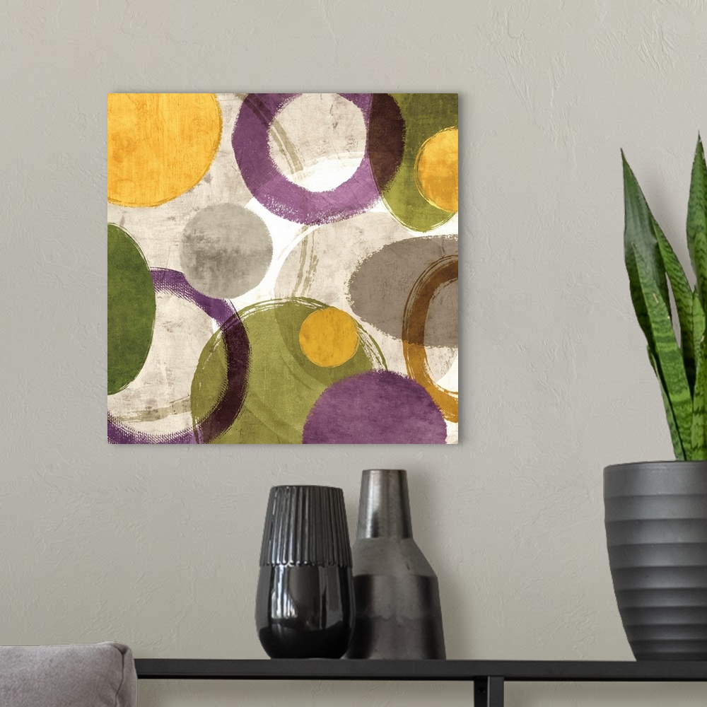 A modern room featuring Square abstract art created with green, gold, purple, white, and gray different styled circles on...