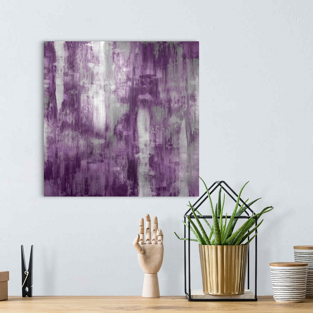A bohemian room featuring Square abstract painting with silver and purple hues running down the canvas.