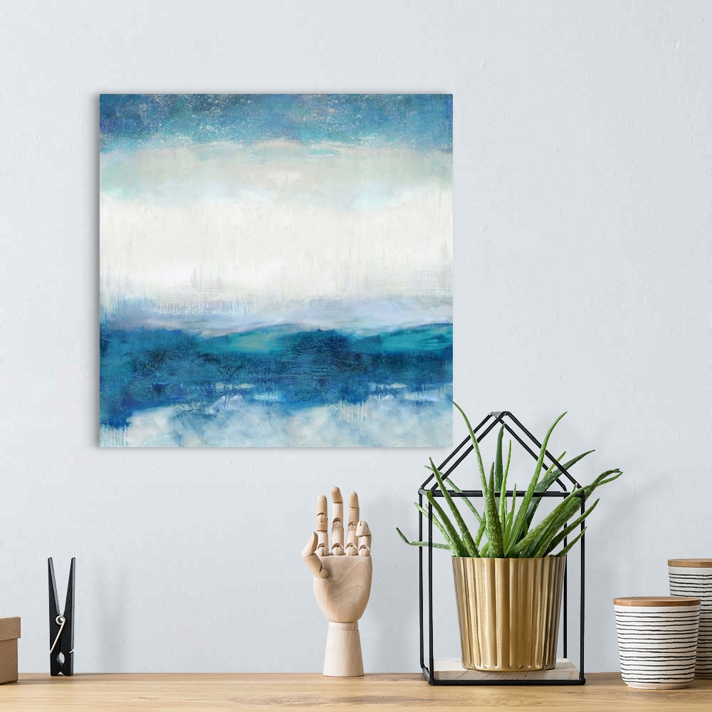 A bohemian room featuring Square abstract painting made with shades of blue and white.