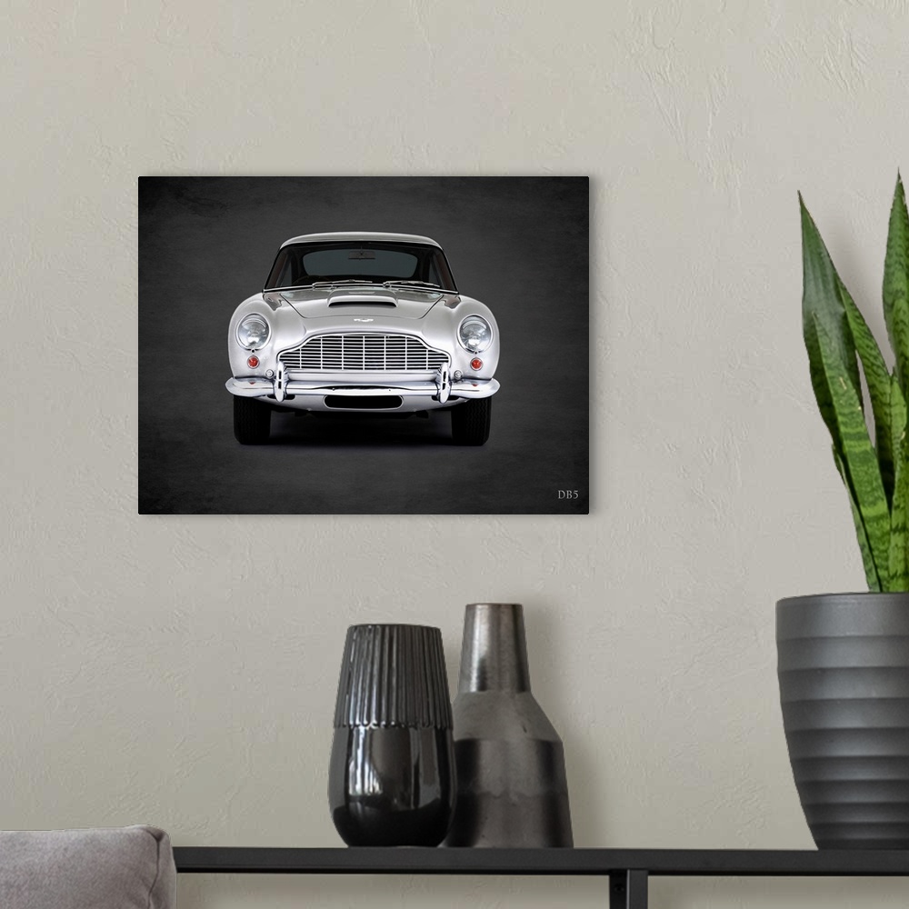 A modern room featuring Photograph of a silver 1965 Aston Martin DB5 printed on a black background with a dark vignette.