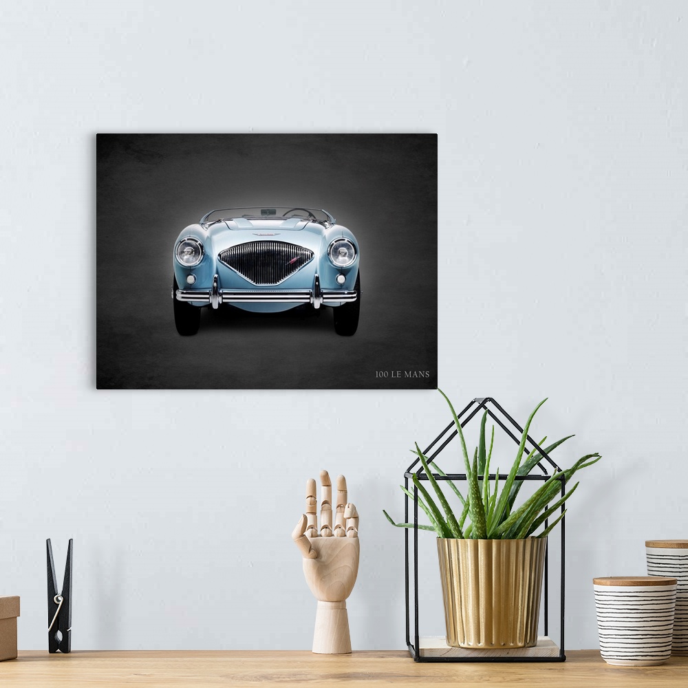 A bohemian room featuring Photograph of a powder blue 1956 Austin-Healey 100 LeMans printed on a black background with a da...