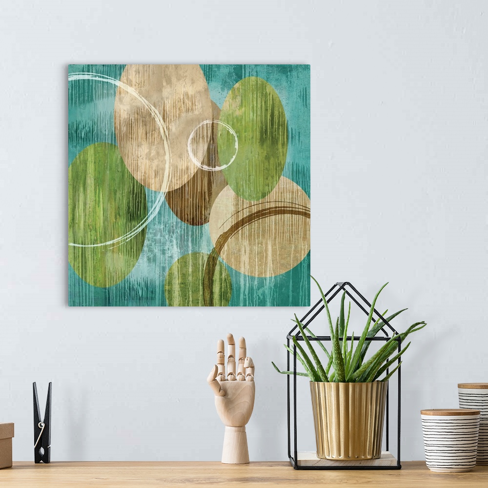 A bohemian room featuring Square abstract art with green, brown, and white circles on a teal background with white paint dr...