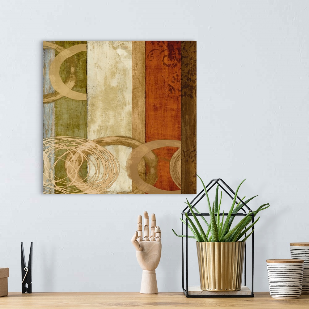 A bohemian room featuring Square abstract art with colorful vertical lines on the background and cream and gold circles on ...