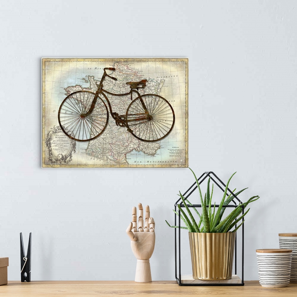 A bohemian room featuring Vintage decor with a silhouette of a bicycle on top of a map of France.