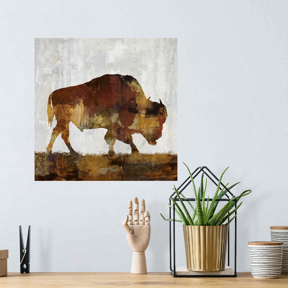 A bohemian room featuring Square decor with a brown and gold silhouette of a bison on a gray, tan, and white background.