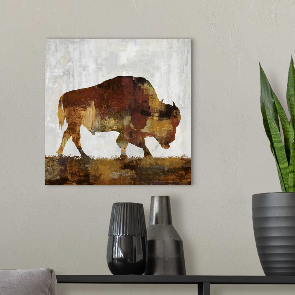 A modern room featuring Square decor with a brown and gold silhouette of a bison on a gray, tan, and white background.
