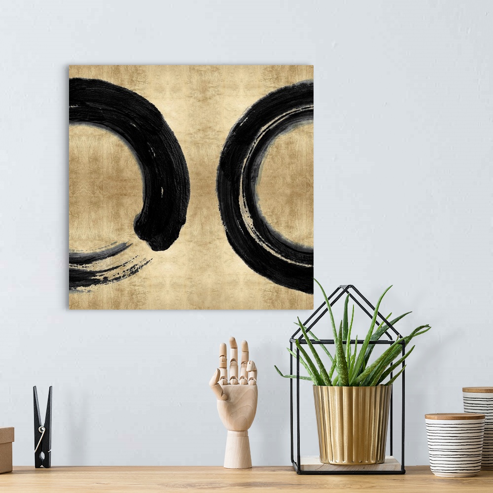 A bohemian room featuring This Zen artwork features two sweeping circular brush strokes in black over a mottled gold color ...
