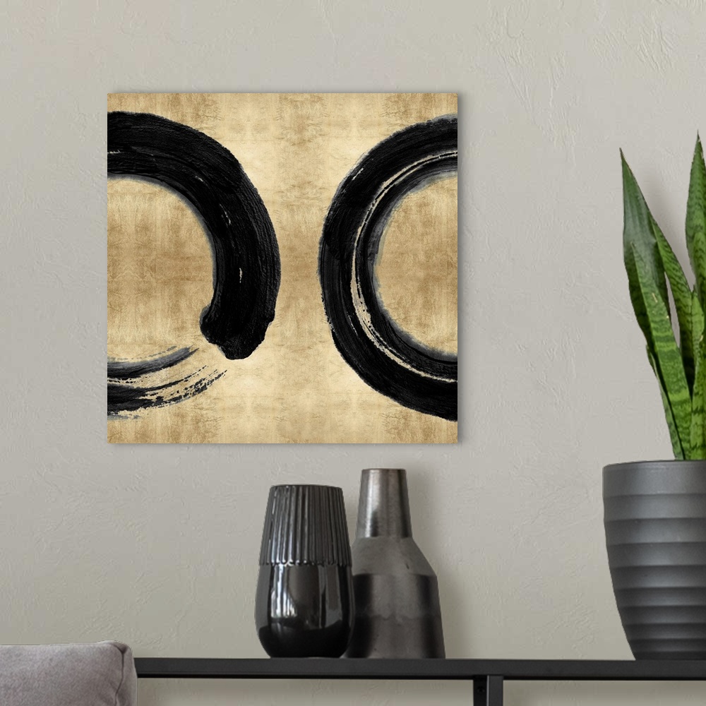 A modern room featuring This Zen artwork features two sweeping circular brush strokes in black over a mottled gold color ...