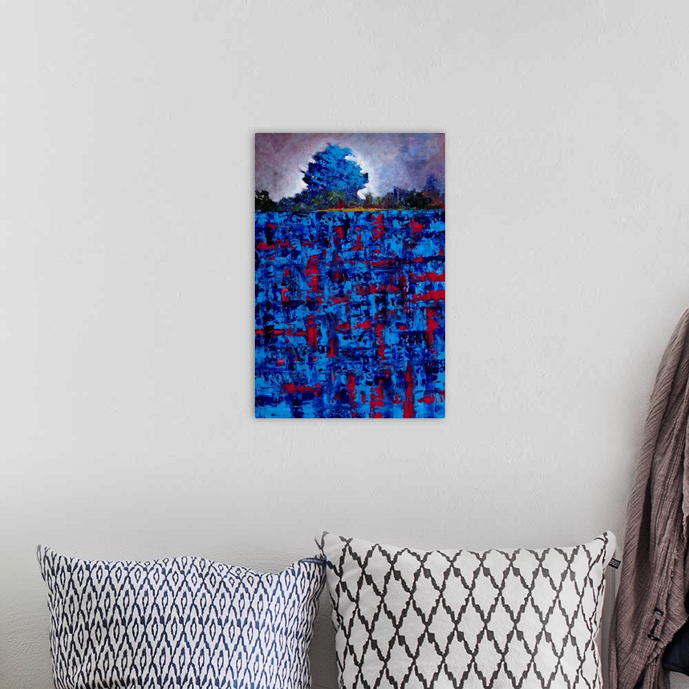 A bohemian room featuring Abstract landscape created with vibrant blue and red hues of a single tree in a field.