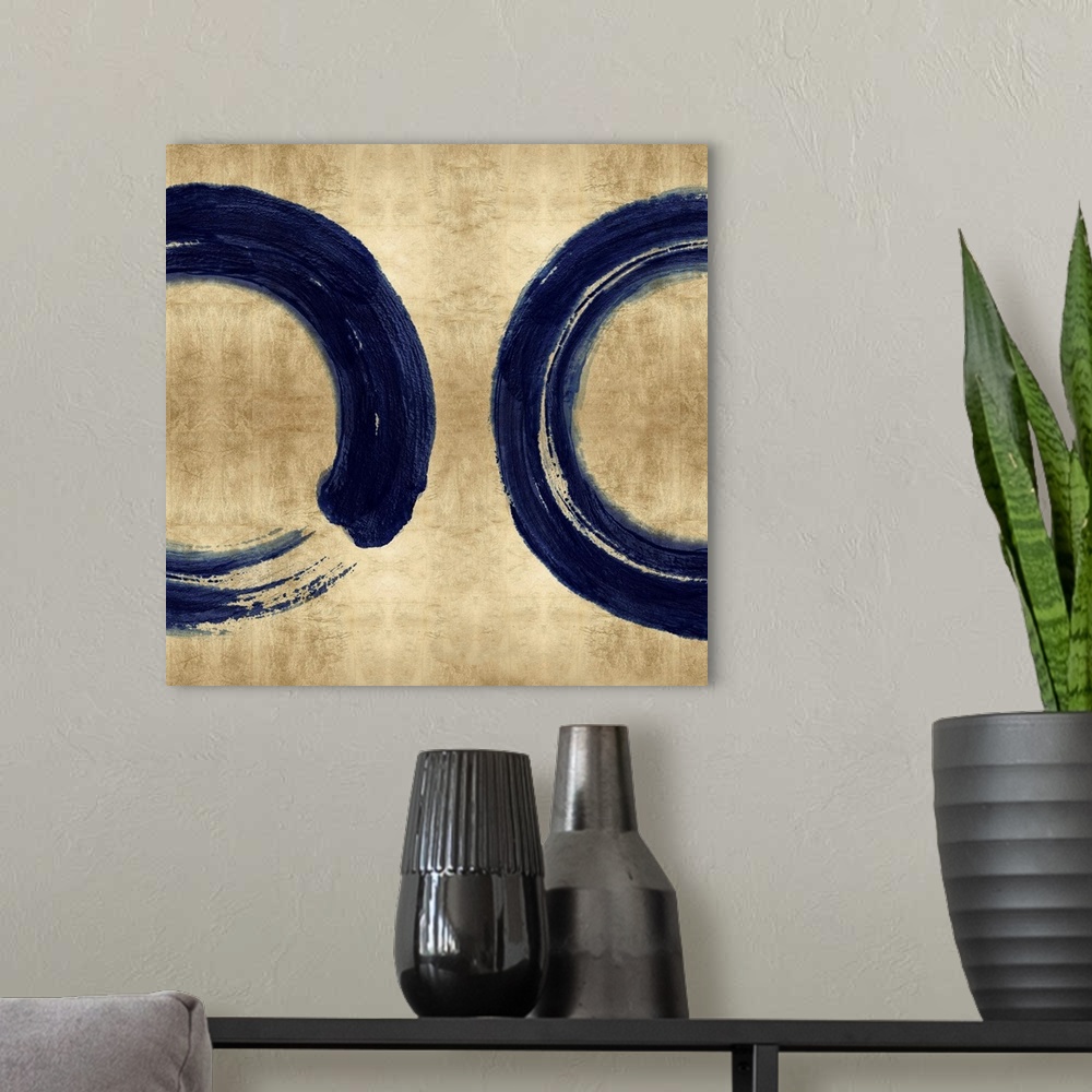 A modern room featuring This Zen artwork features two sweeping circular brush strokes in blue over a mottled gold color b...