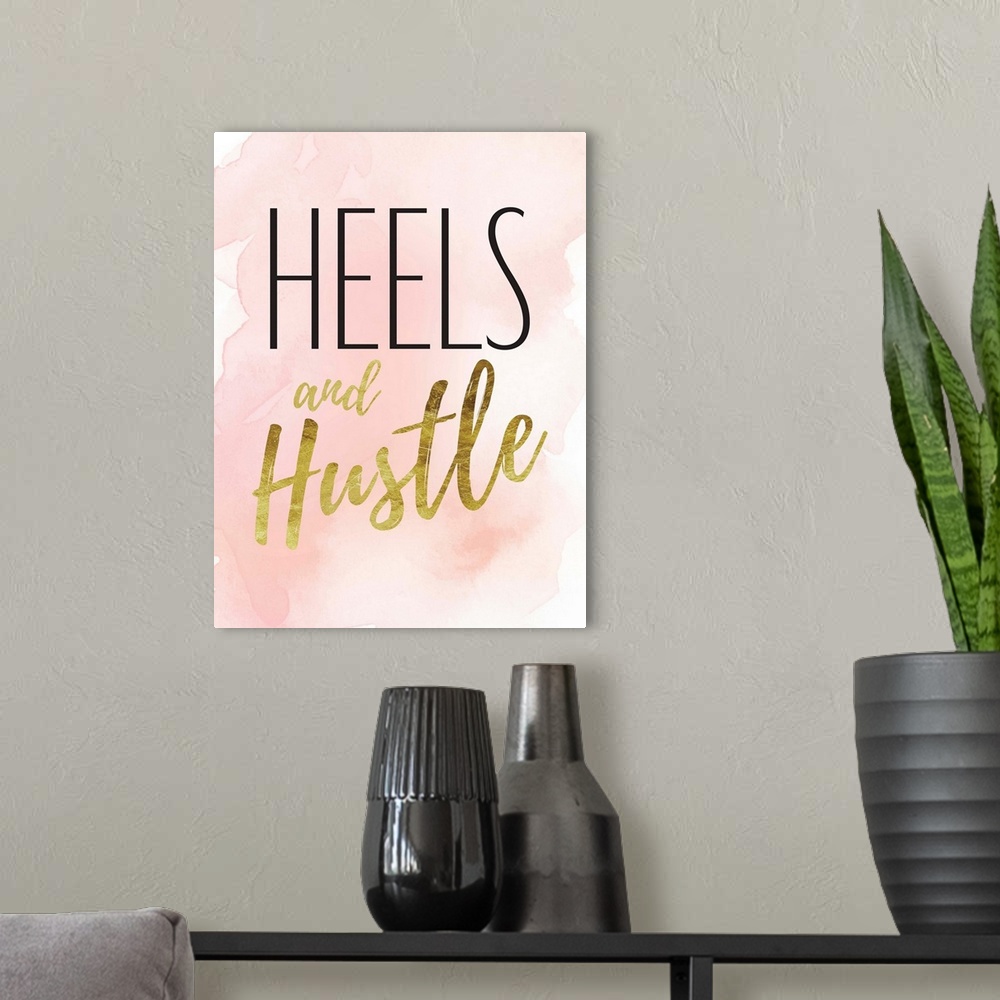 A modern room featuring Decorative artwork with the words: Heels and Hustle.