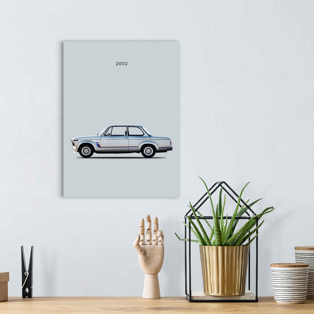 A bohemian room featuring Photograph of a silver BMW 2002 Turbo printed on a gray background