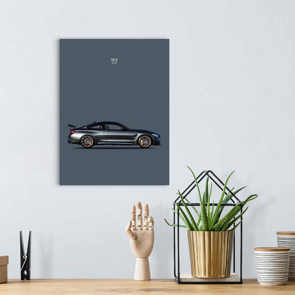A bohemian room featuring Photograph of a dark gray BMW M4 GTS printed on a dark gray background