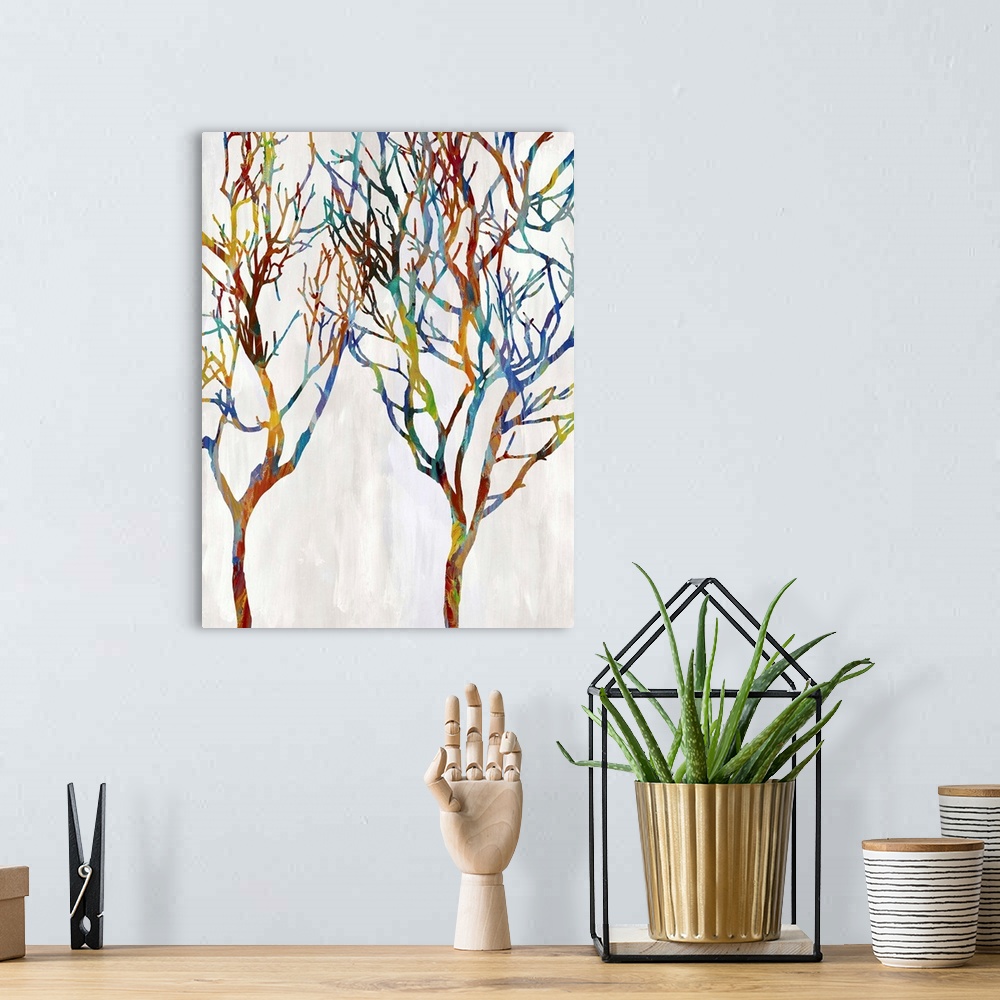 A bohemian room featuring Colorful silhouettes of two leafless trees on a white and gray background.