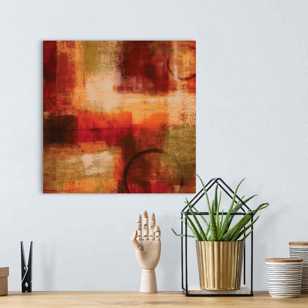 A bohemian room featuring Square abstract painting with warm splotches of color and two circular figures.