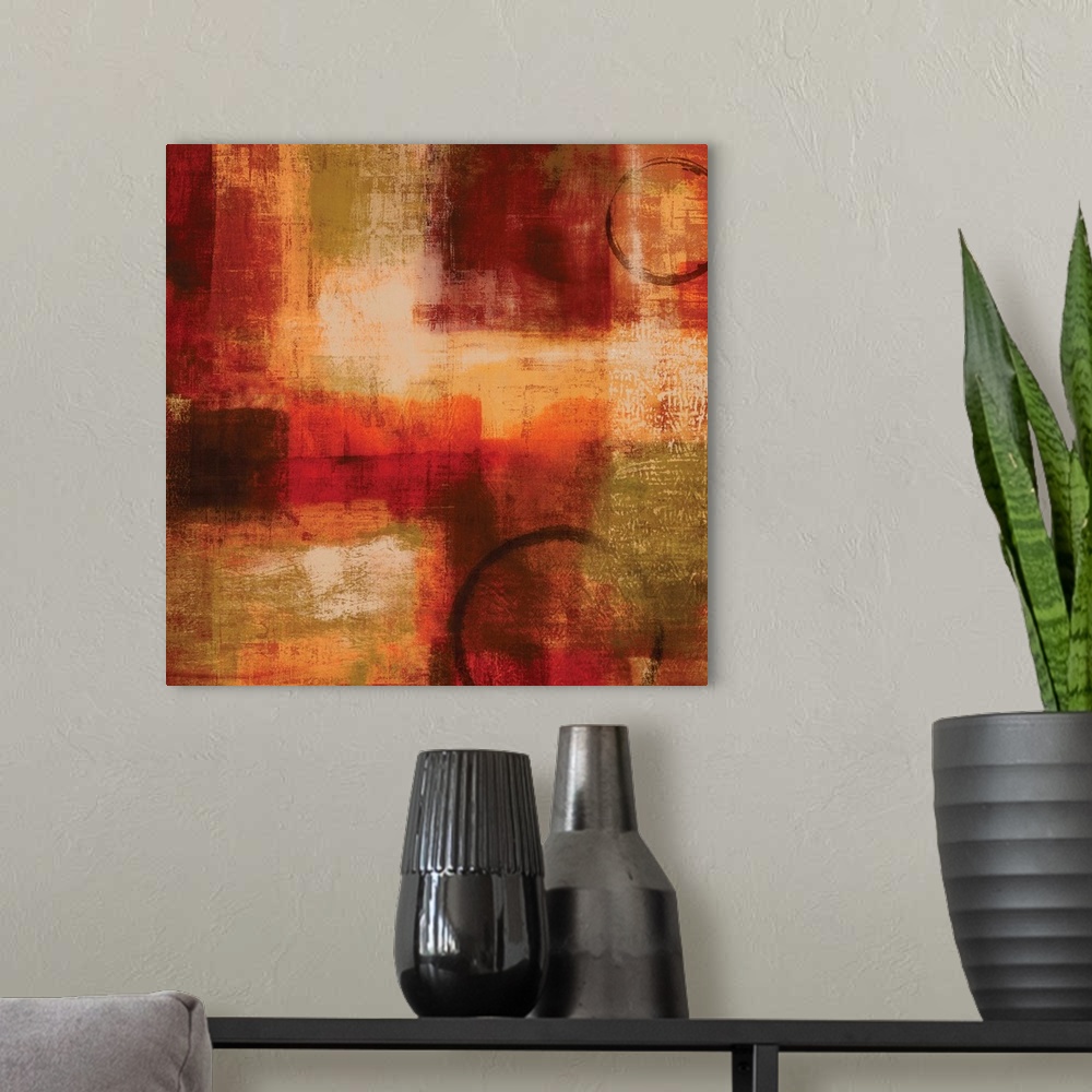 A modern room featuring Square abstract painting with warm splotches of color and two circular figures.
