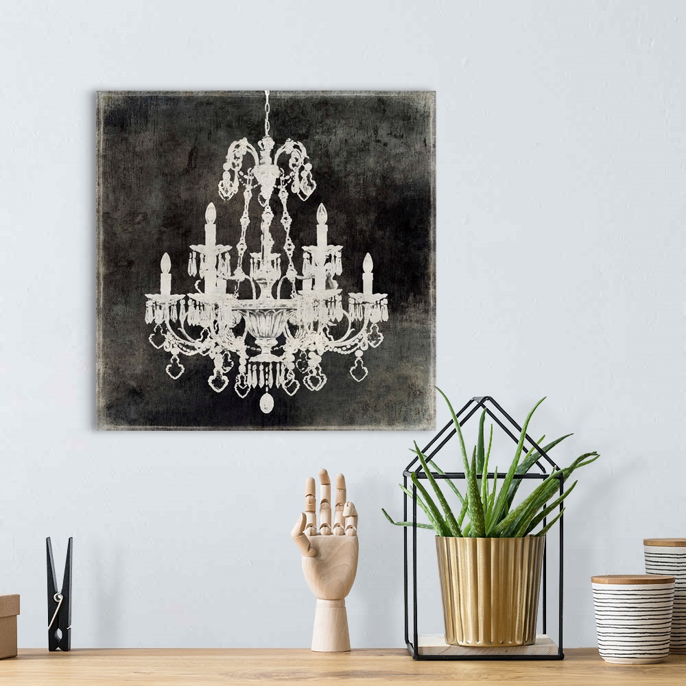 A bohemian room featuring Square decor with a silver chandelier on a distressed black background.