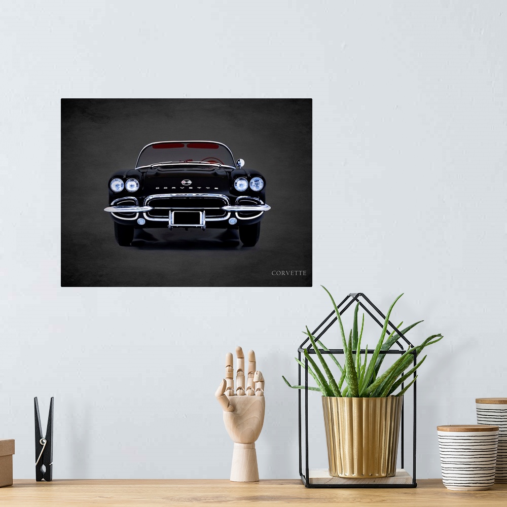 A bohemian room featuring Photograph of a black 1962 Chevrolet Corvette printed on a black background with a dark vignette.