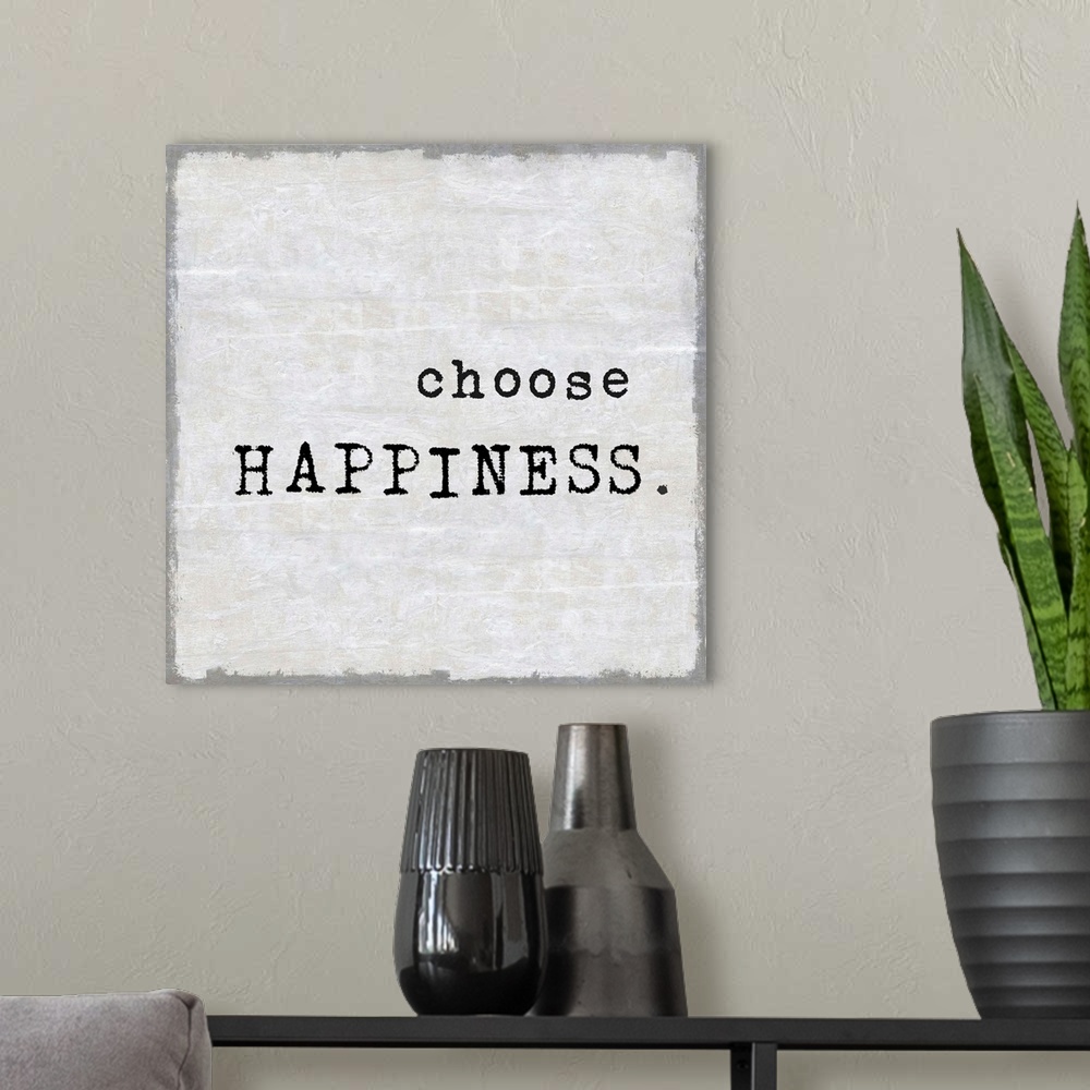 A modern room featuring "Choose Happiness" on a square background in shades of gray.